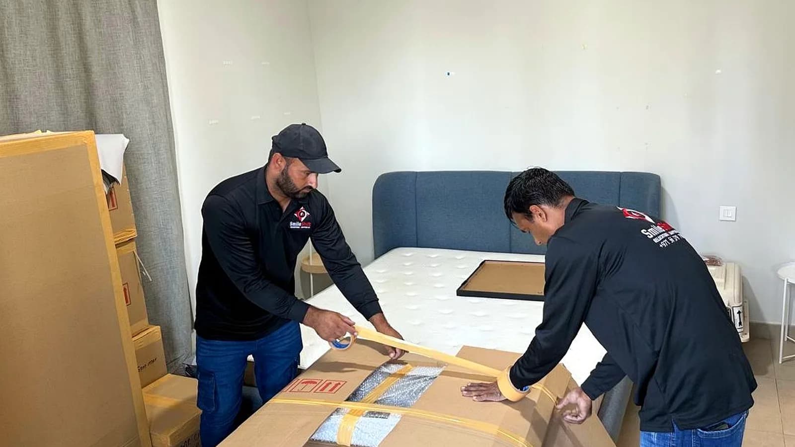 SmileShift crew packing household goods for a move from Dubai to India