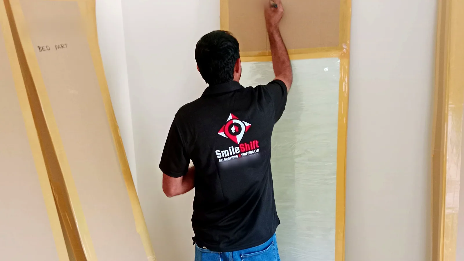 Professional movers wrapping fragile items for a Dubai relocation